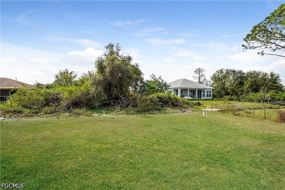 3707 10th Street Southwest Lehigh Acres, FL 33976 - Photo 14 of 15 a swimming pool with trees in the background