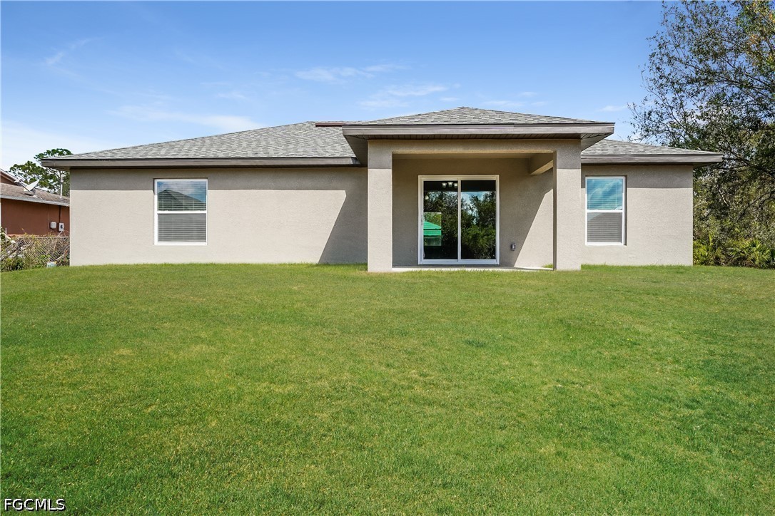 3707 10th Street Southwest Lehigh Acres, FL 33976 - Photo 15 of 15 a view of a house with a yard
