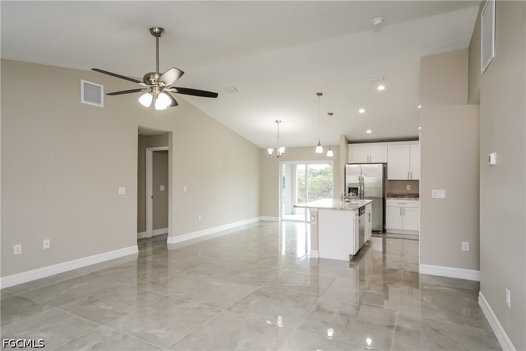 3707 10th Street Southwest Lehigh Acres, FL 33976 - Photo 3 of 15 a view of a kitchen with a refrigerator and microwave