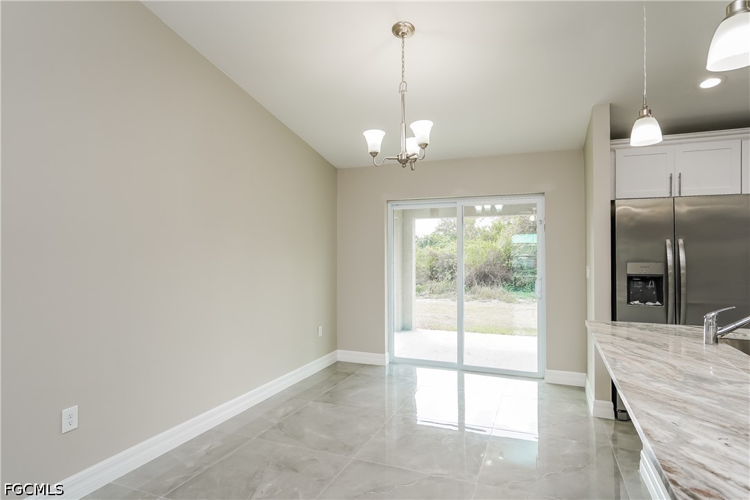 3707 10th Street Southwest Lehigh Acres, FL 33976 - Photo 5 of 15 a view of a room with a chandelier