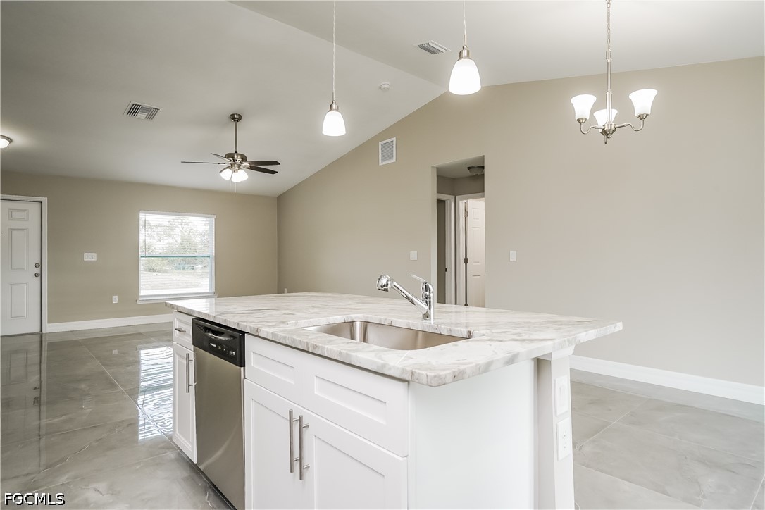 3707 10th Street Southwest Lehigh Acres, FL 33976 - Photo 6 of 15 a bathroom with a sink a chandelier and a mirror