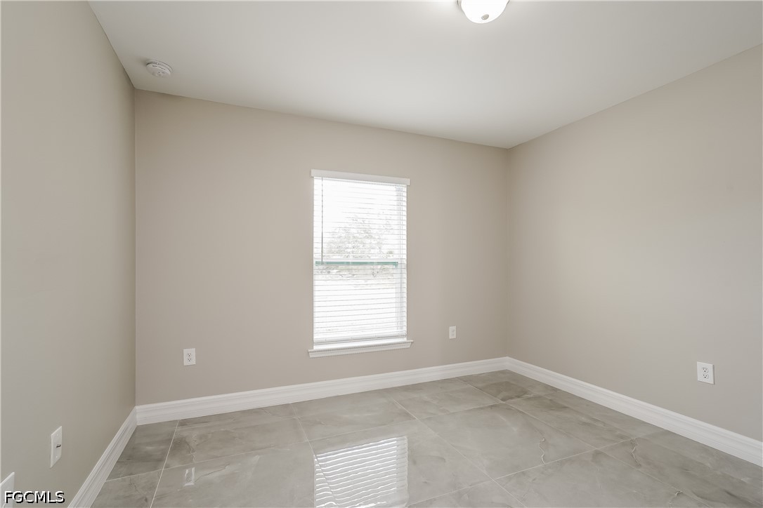3707 10th Street Southwest Lehigh Acres, FL 33976 - Photo 9 of 15 an empty room with a window