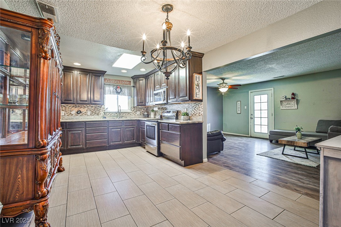 2540 Eagle Street Las Vegas, NV 89142 - Photo 12 of 29 Kitchen with light countertops, a skylight, applia