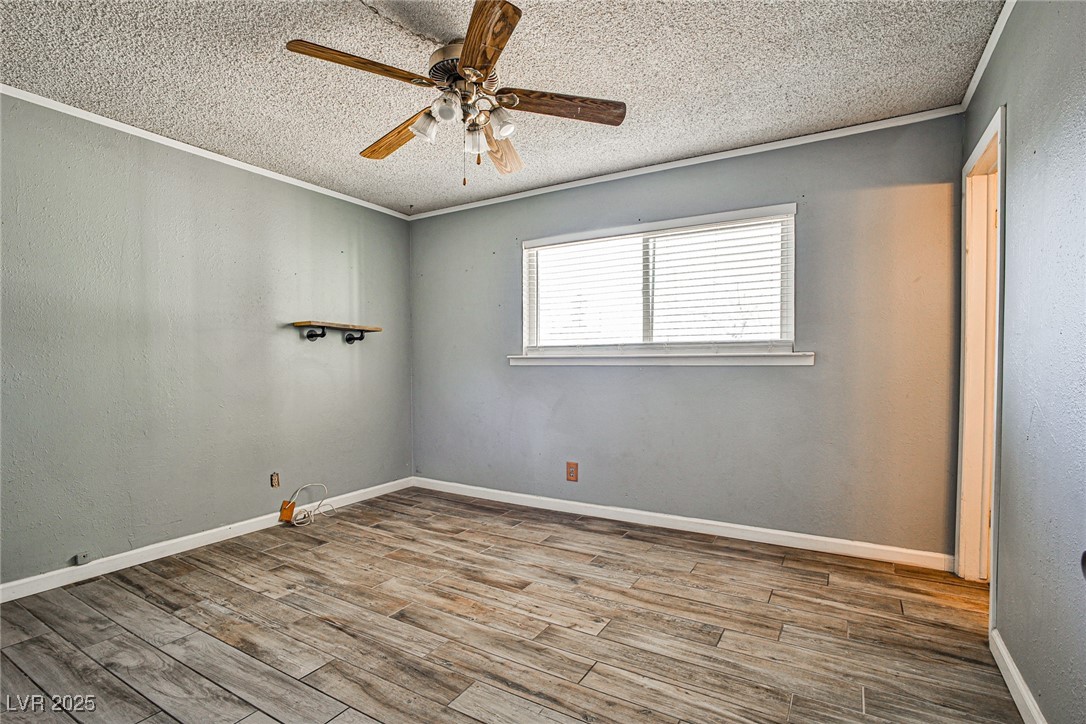 2540 Eagle Street Las Vegas, NV 89142 - Photo 22 of 29 Unfurnished room with crown molding, wood finished