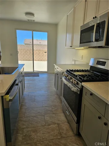 a bathroom with a sink a toilet and a large mirror