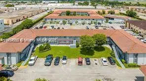 a view of swimming pool with a garden and plants