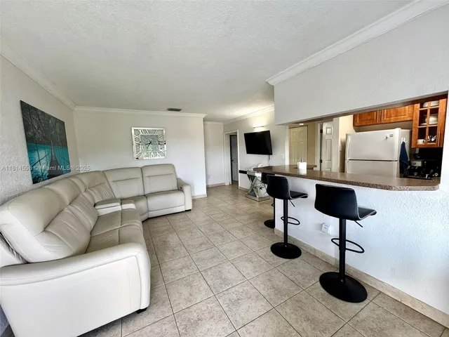 a living room with furniture and a lamp