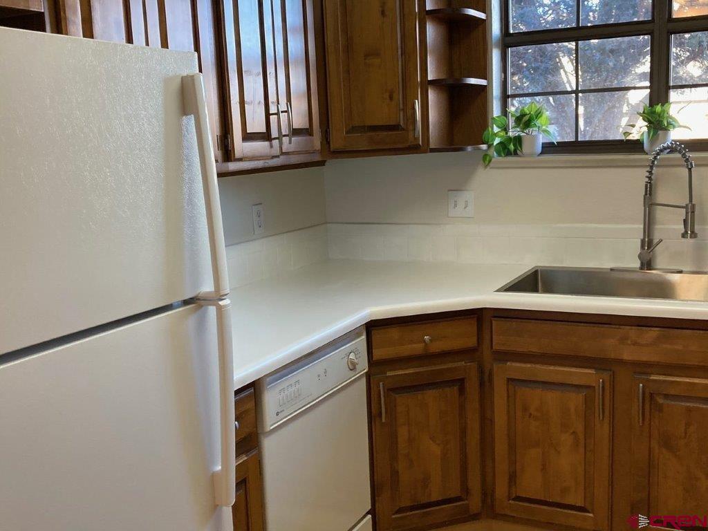 2721 Patterson Road, Unit 404 Grand Junction, CO 81506 - Photo 12 of 26 a kitchen with a refrigerator and a sink
