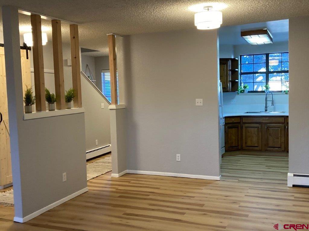 2721 Patterson Road, Unit 404 Grand Junction, CO 81506 - Photo 9 of 26 an empty room with wooden floor and windows