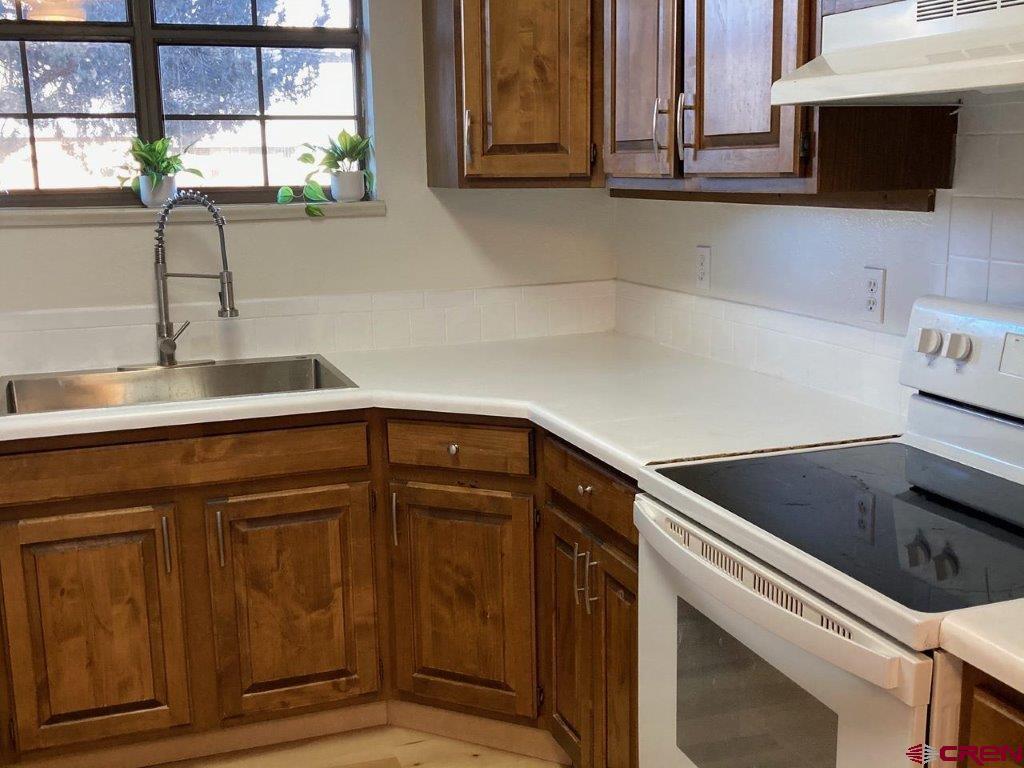 2721 Patterson Road, Unit 404 Grand Junction, CO 81506 - Photo 10 of 26 a kitchen with stainless steel appliances granite countertop a sink and a microwave