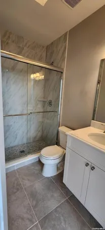a bathroom with a toilet and a shower