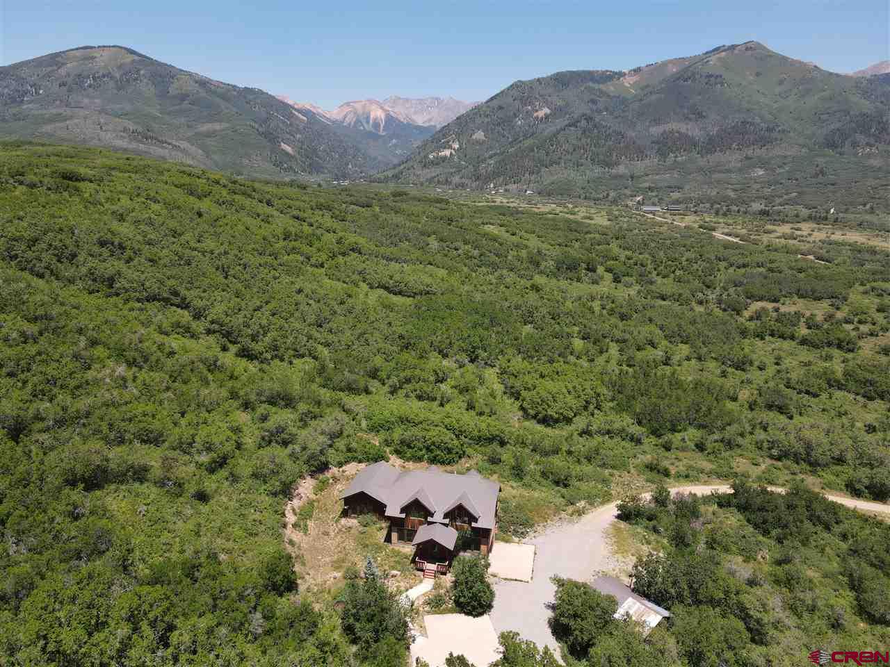 a view of a lush green hillside and a building