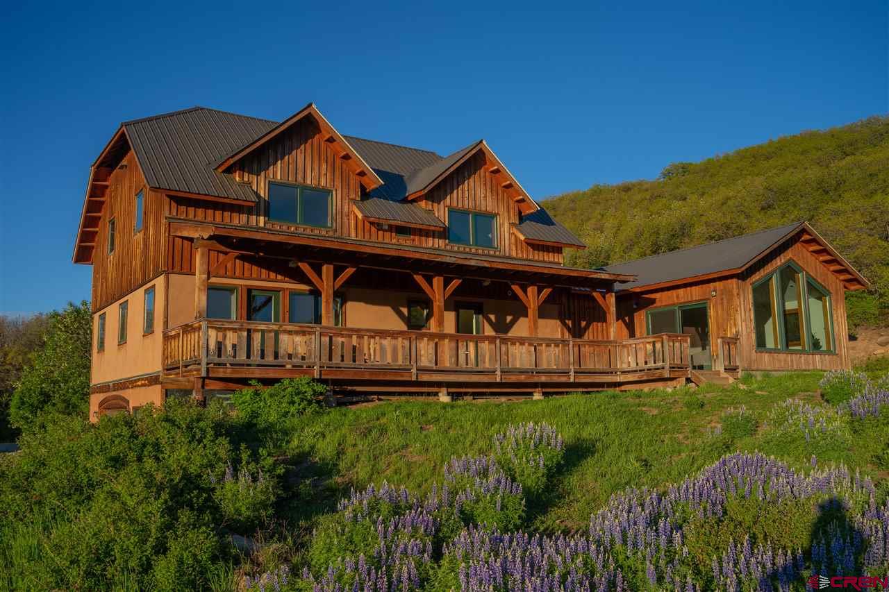2529 County Road 124 Mancos, CO 81328 - Photo 2 of 34 a front view of house with garden