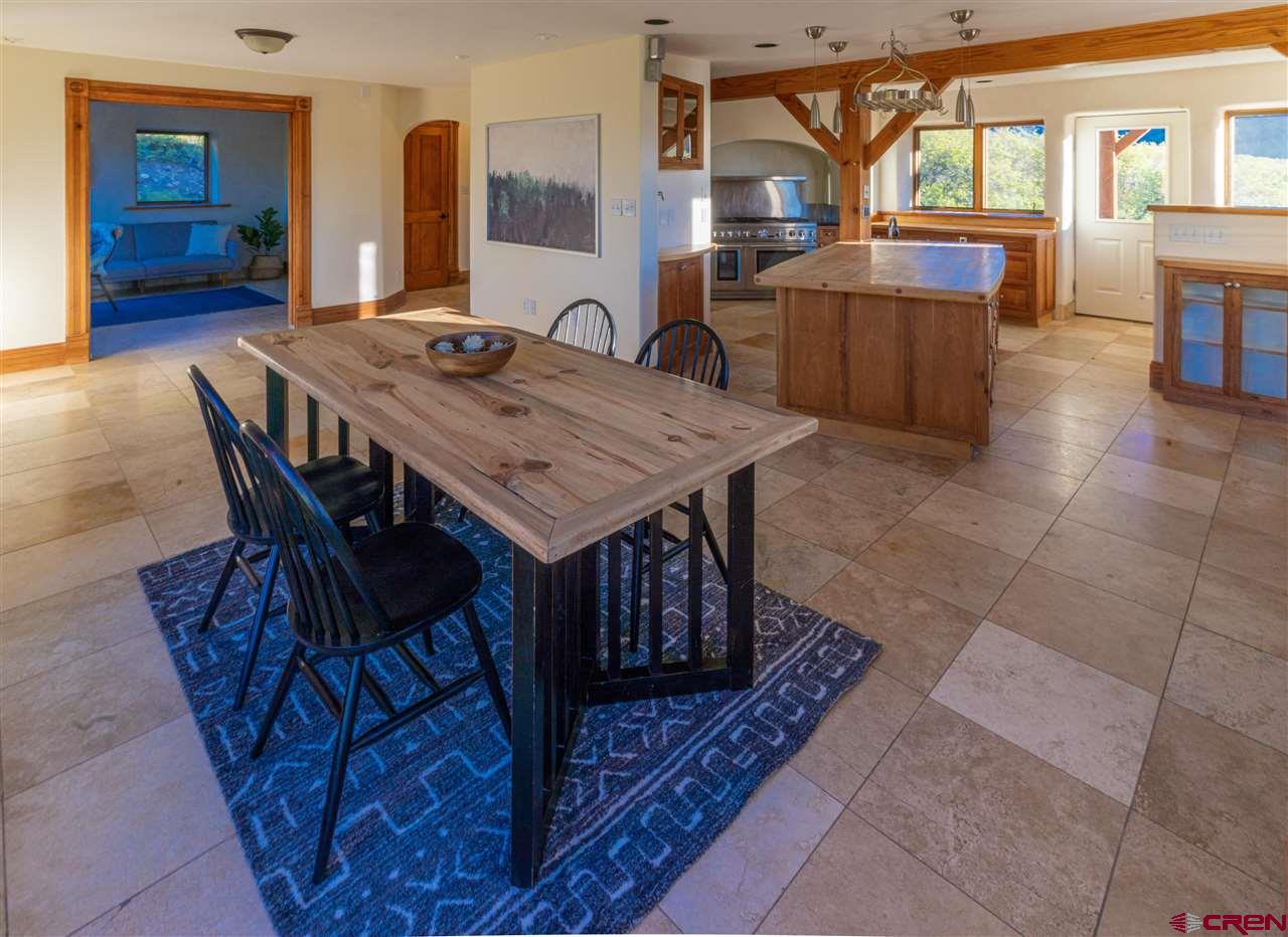 2529 County Road 124 Mancos, CO 81328 - Photo 11 of 34 a view of a dining room with furniture window and wooden floor