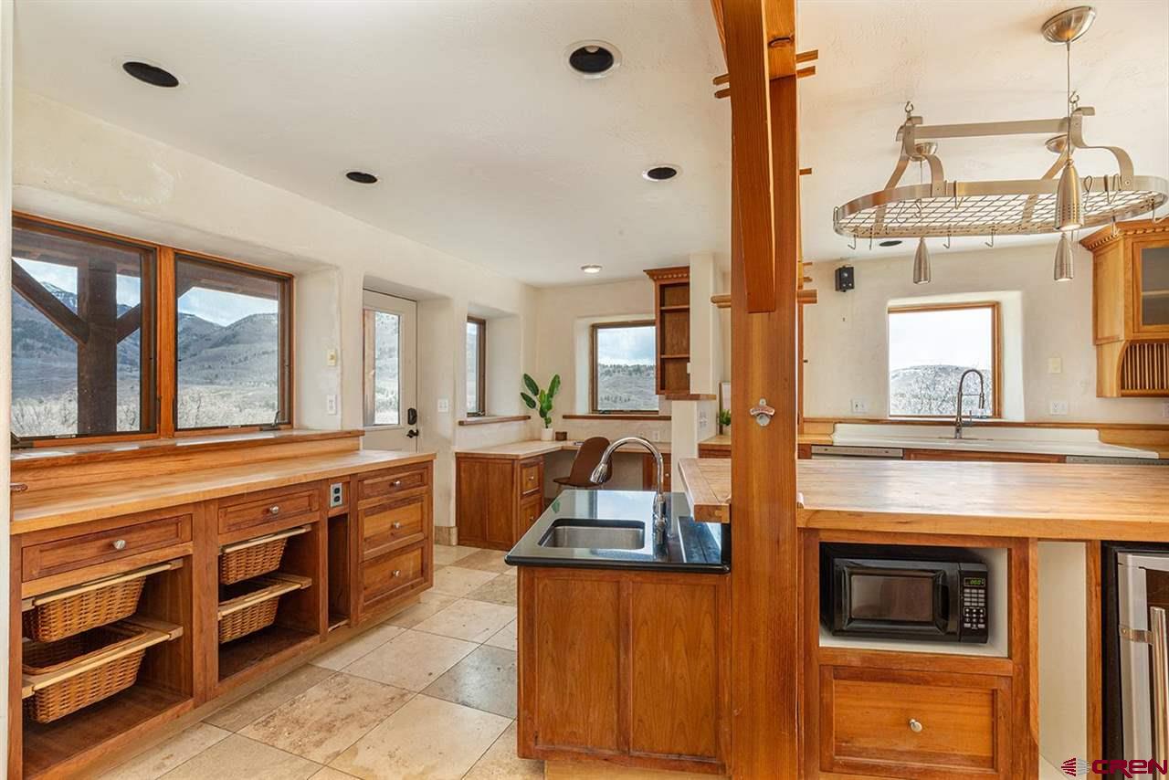 2529 County Road 124 Mancos, CO 81328 - Photo 12 of 34 a kitchen with stainless steel appliances granite countertop a stove and more cabinets
