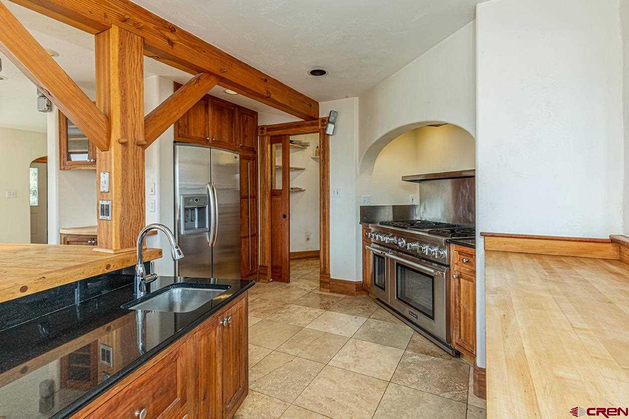 2529 County Road 124 Mancos, CO 81328 - Photo 15 of 34 a kitchen with stainless steel appliances granite countertop a stove a sink and a microwave