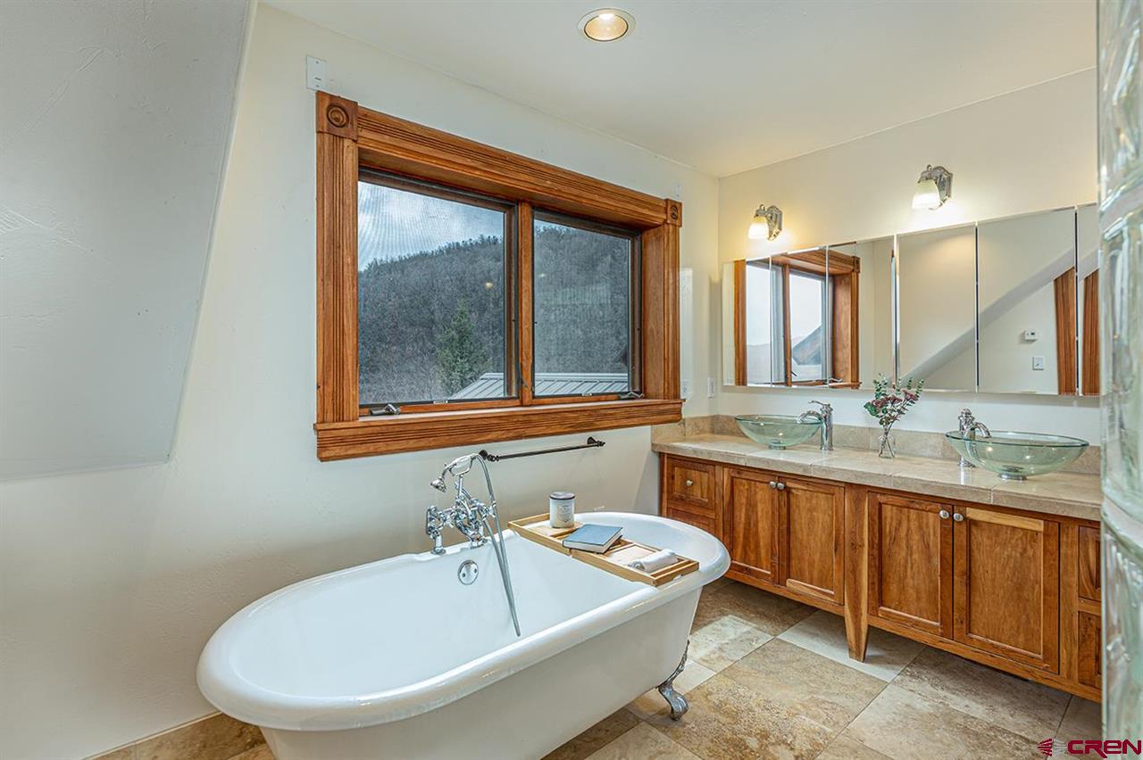 2529 County Road 124 Mancos, CO 81328 - Photo 18 of 34 a bathroom with a tub sink and mirror