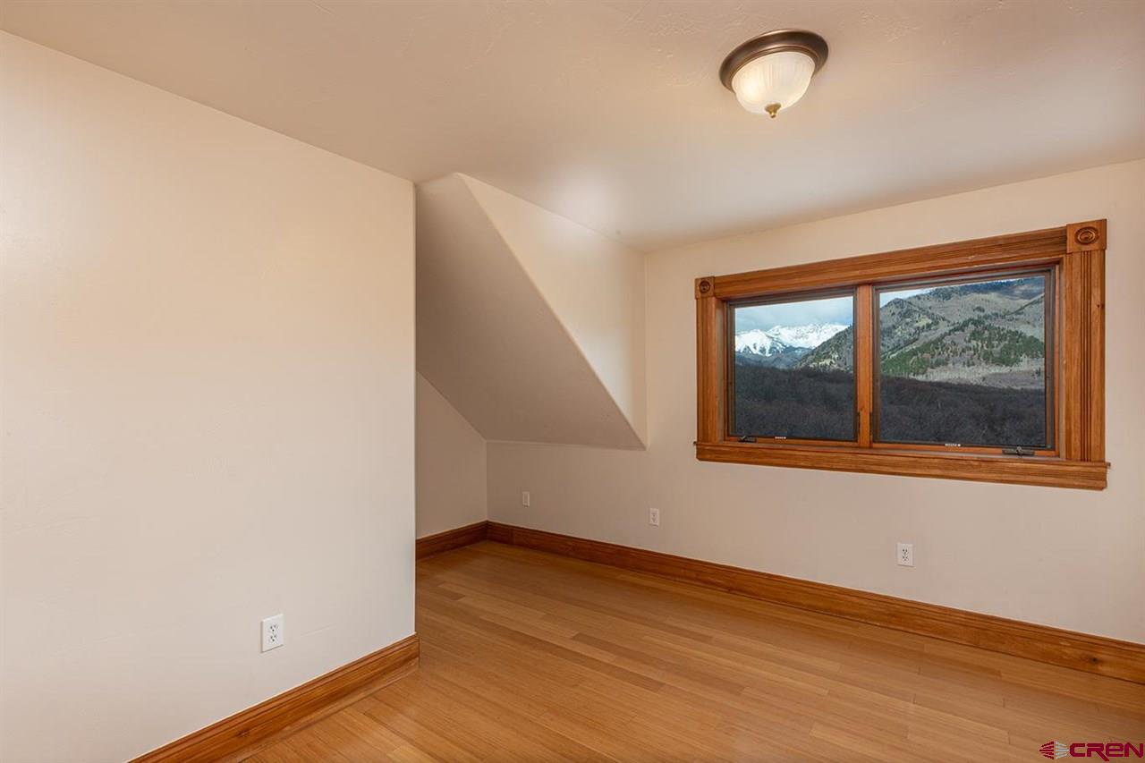2529 County Road 124 Mancos, CO 81328 - Photo 21 of 34 a view of an empty room with wooden floor and a window