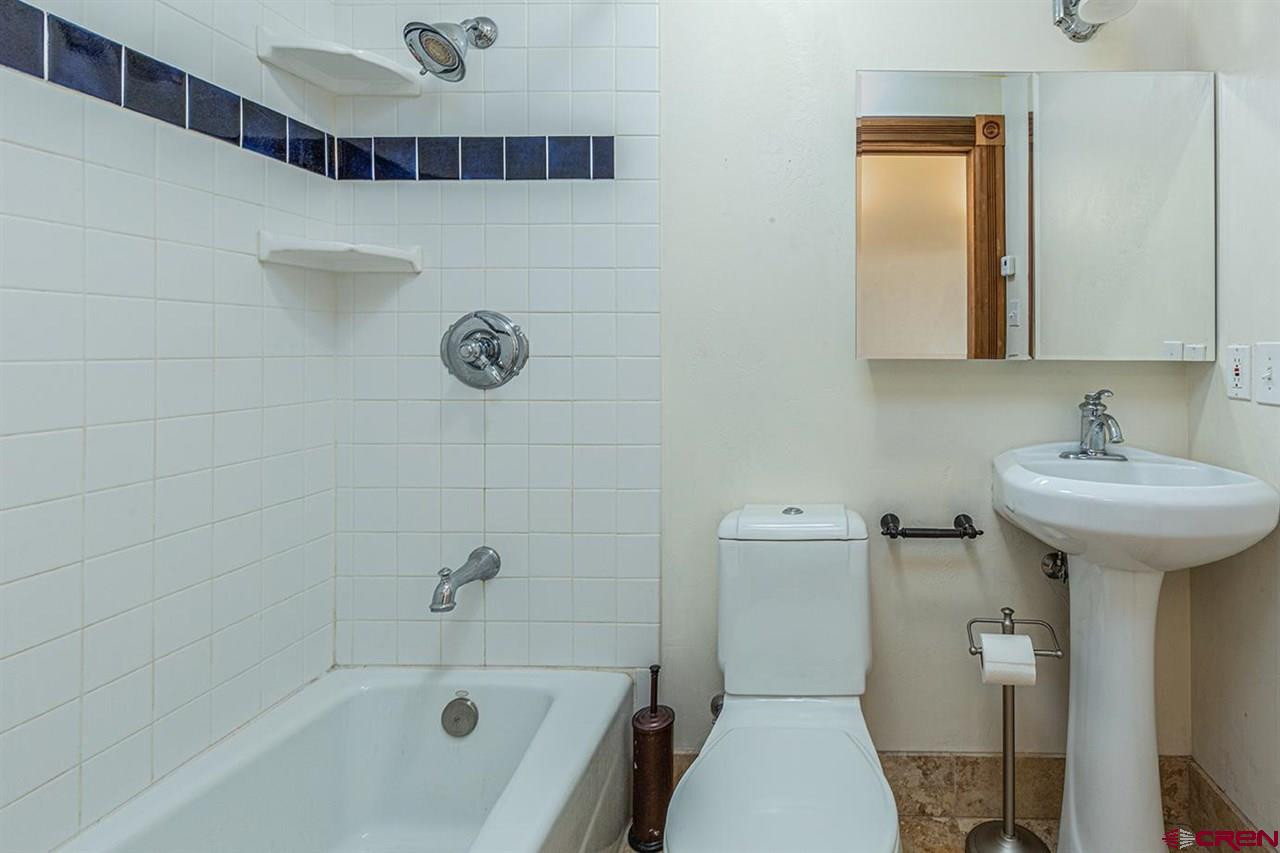 2529 County Road 124 Mancos, CO 81328 - Photo 23 of 34 a bathroom with a sink a toilet and shower