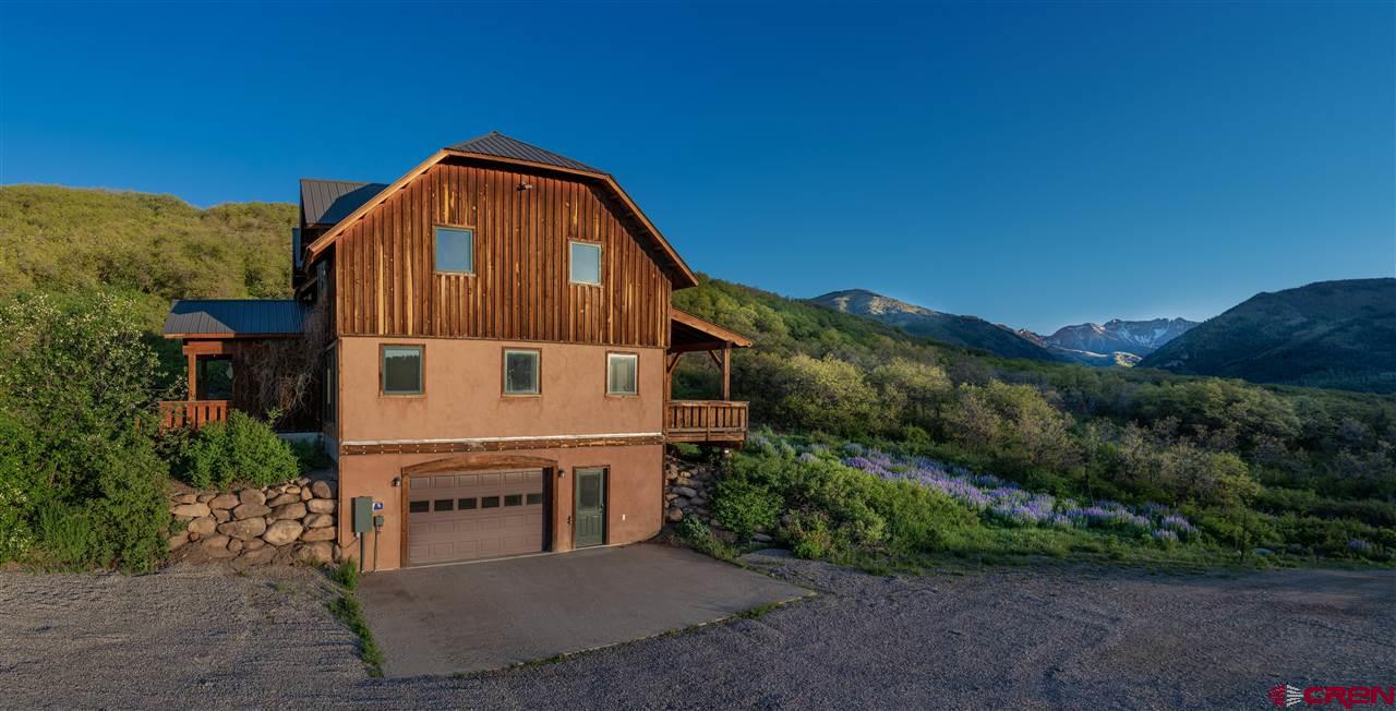 2529 County Road 124 Mancos, CO 81328 - Photo 4 of 34 a view of a small house with a yard and large trees