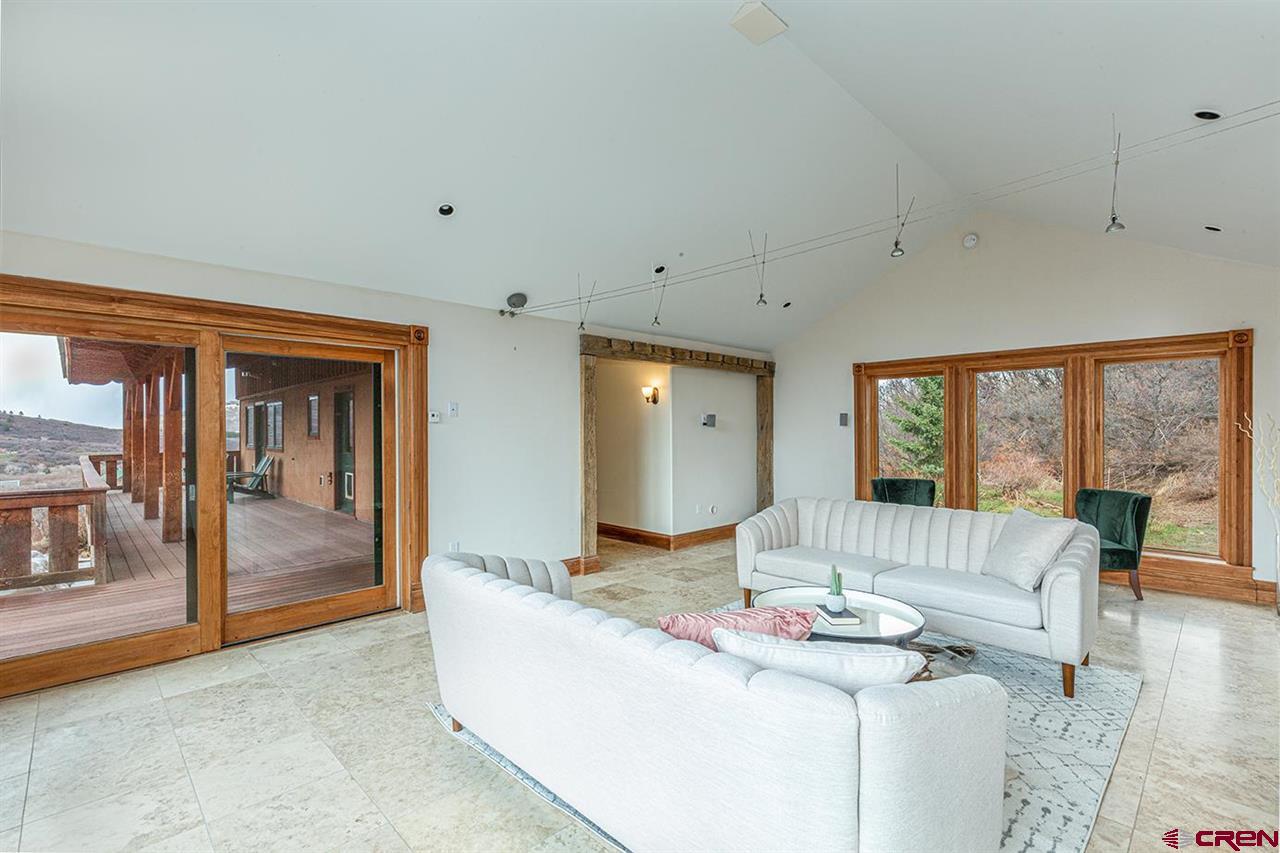 2529 County Road 124 Mancos, CO 81328 - Photo 10 of 34 a living room with fireplace furniture and floor to ceiling window