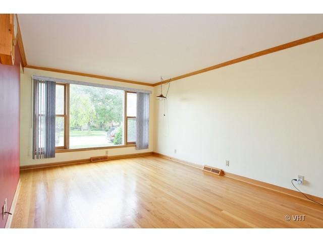 8400 South Kenneth Avenue Chicago, IL 60652 - Photo 2 of 16 a view of empty room with wooden floor and fan
