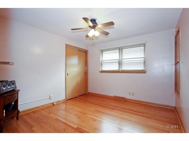 8400 South Kenneth Avenue Chicago, IL 60652 - Photo 11 of 16 a view of an empty room with window and wooden floor