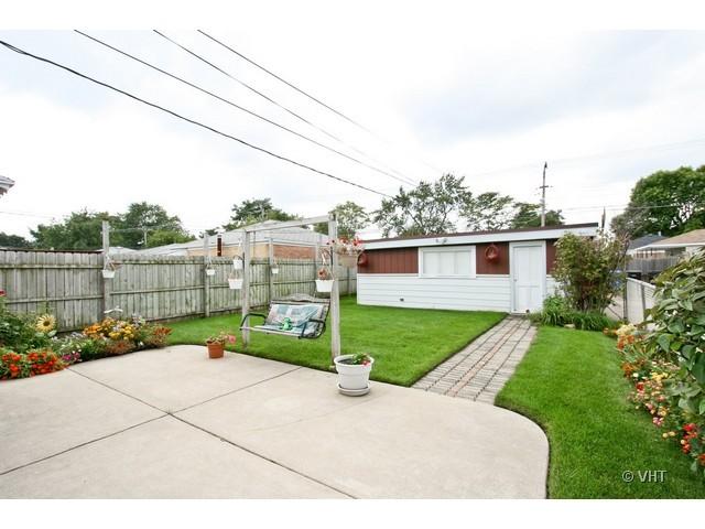 8400 South Kenneth Avenue Chicago, IL 60652 - Photo 16 of 16 a view of a backyard with plants and a garden