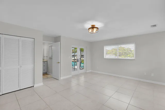a view of an empty room with glass door