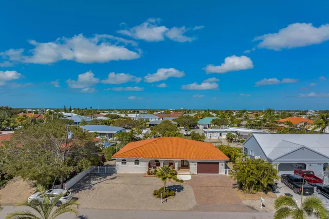 an aerial view of a houses with a swimming pool