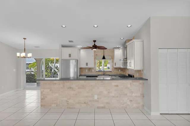 a view of a kitchen with kitchen island a counter top space and cabinets