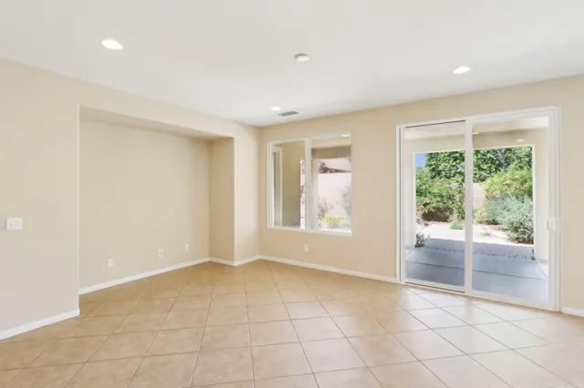 a large white kitchen with a large window