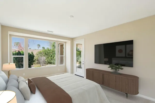 a bedroom with a bed and a flat screen tv