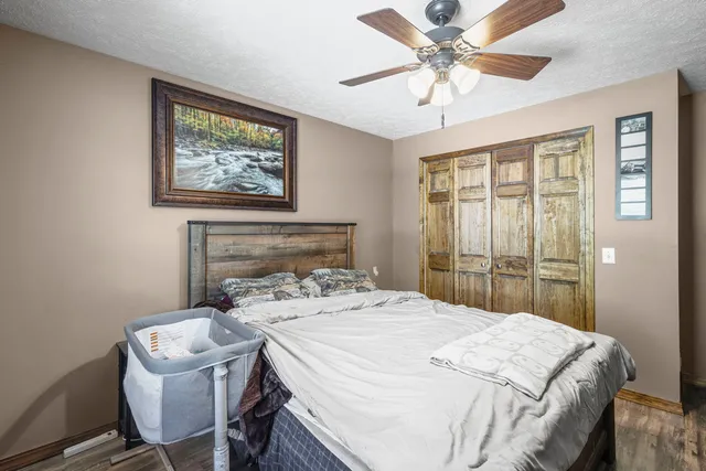 a bedroom with a bed and a chandelier