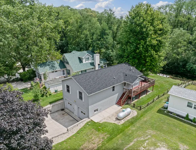 an aerial view of a house with a big yard