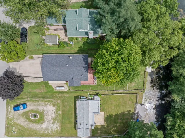 an aerial view of a house with outdoor space
