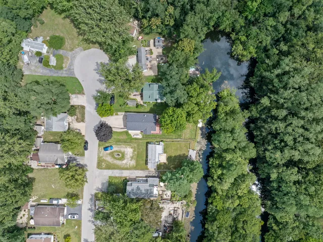an aerial view of a house with a yard and outdoor seating