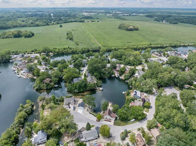 an aerial view of a houses with a lake view