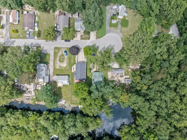 an aerial view of a house with a yard and garden
