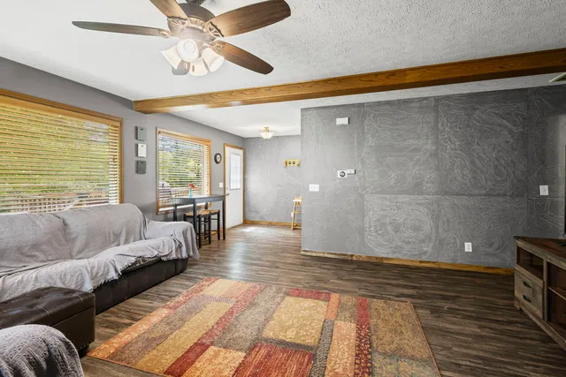 a living room with furniture and a floor to ceiling window