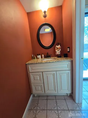 a bathroom with a sink mirror vanity and a toilet