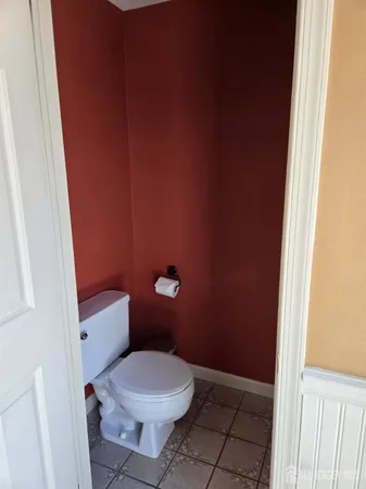 a white toilet sitting next to a shower