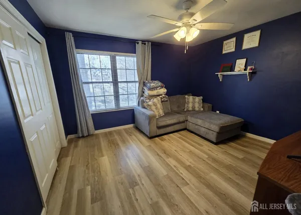 a spacious bedroom with a bed and a chandelier