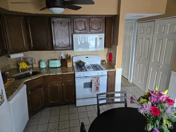 a kitchen with stainless steel appliances granite countertop a sink dishwasher stove and cabinets