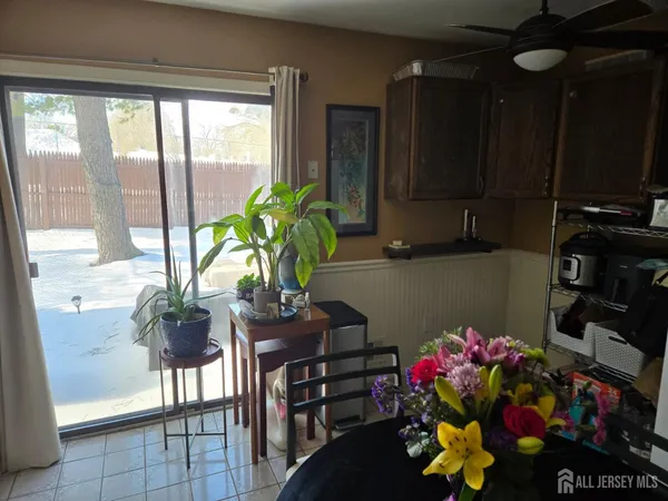 a vase of flowers sitting on a table near a window