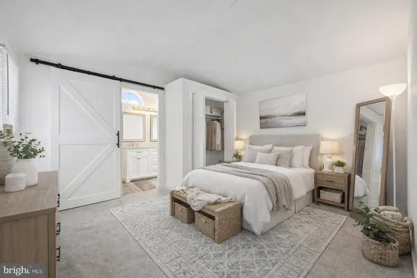 a spacious bedroom with a bed and a cabinets