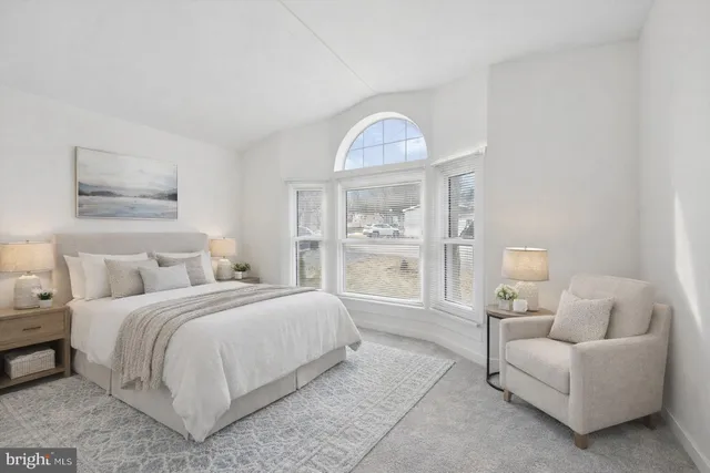 a bedroom with bed and a window