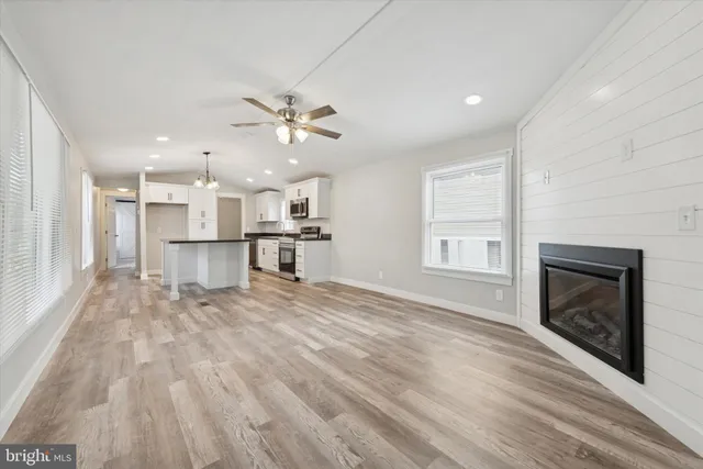 a view of a kitchen with a stove cabinets wooden floor and a kitchen
