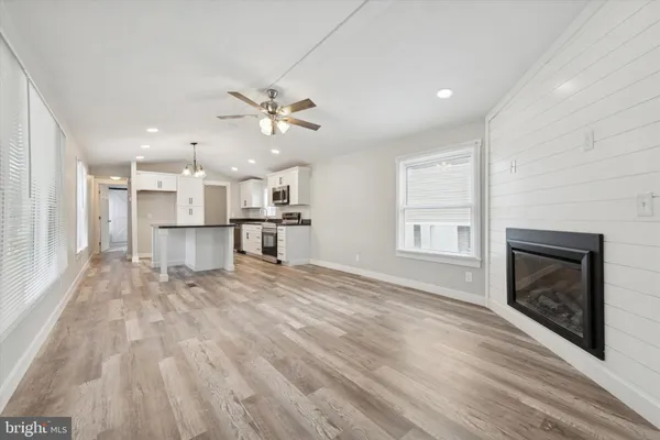 a view of a kitchen with a stove cabinets wooden floor and a kitchen