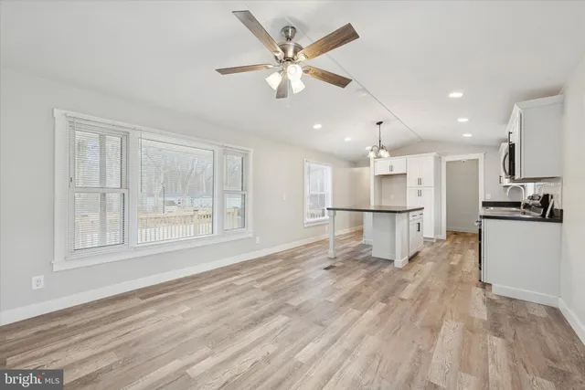 a view of kitchen with sink and refrigerator
